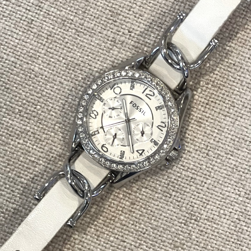 Fossil Women’s watch. White leather band, silver and bling. Great condition.